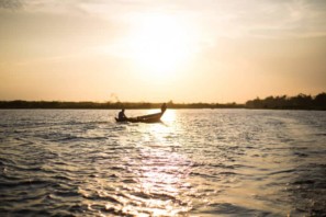 A single boat in the water on Hoi An river at sunset