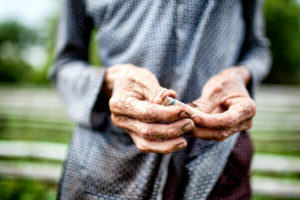 old hands holding money in Vietnam