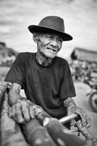 Vietnamse man carrying bamboo on his bicycle