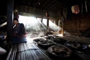 Man sitting in a house drying cheroot leaves in the Shan state, Myanmar