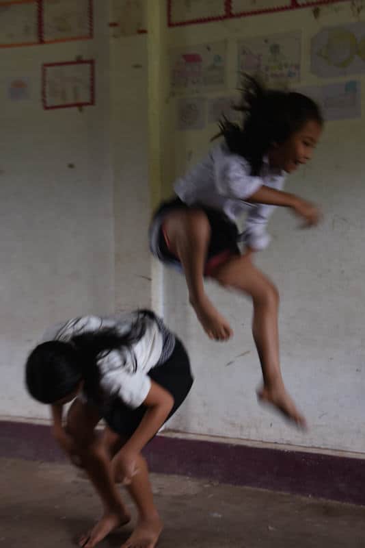 2 girls playing in a school in Laos