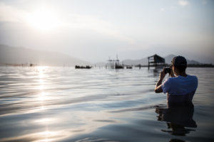 A Pics of Asia photography workshop student gets waist-deep in water for the photo