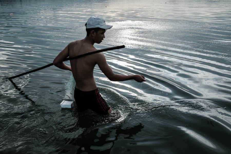 man fishing in Lang Co lagoon