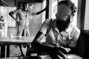 A young man reaches for his tea in a local Sri Lanka tea shop - Pics Of Asia Black And White Photography