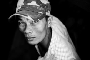 Black and white portrait of a man looking up in Vietnam's Mekong Delta
