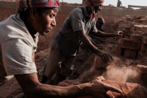 Two men working in a brick factory in Bangladesh early morning