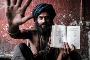 A Sadu in Kolkata, India, showing his study book about the human body during a photography workshop with Pics of Asia