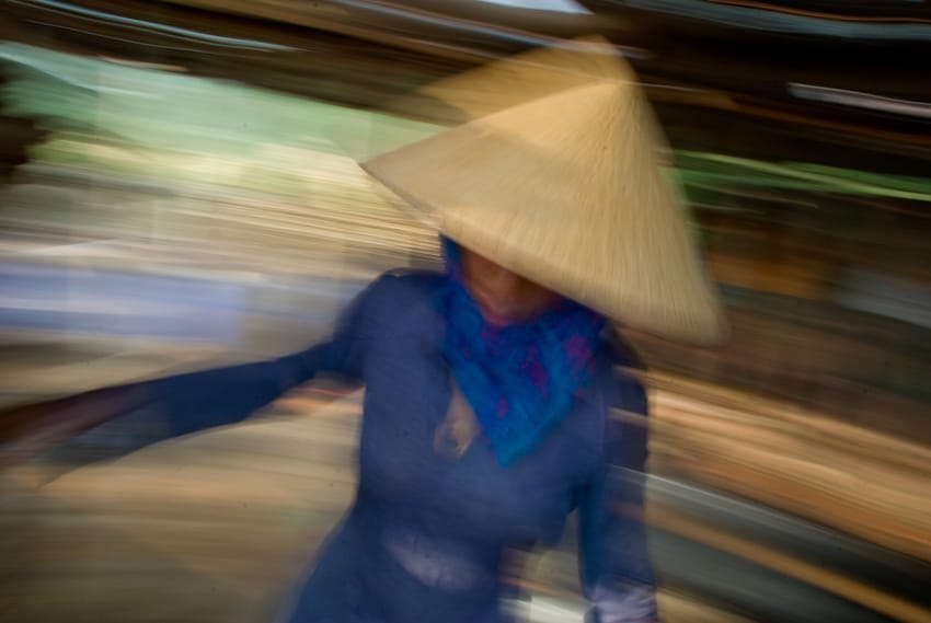 Photo of a Vietnamese woman using a slow shutter speed to increase dynamism to illustrate a tutorial by Pics of Asia