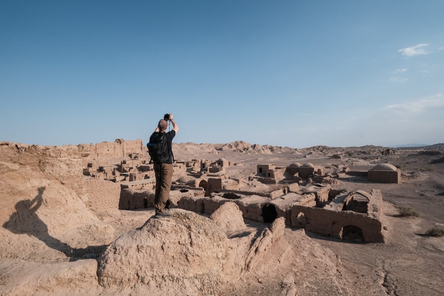 A student from pics of asia taking photos of the old city of Keshit in Iran