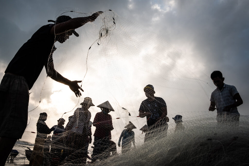 A group of fishermen in central Vietnam cleaning their fishing nets