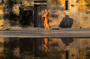 A Buddhist monk walks in the streets of Hoi An old town