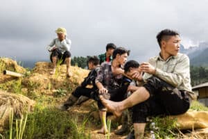 A group of men take a break from working in the rice fields
