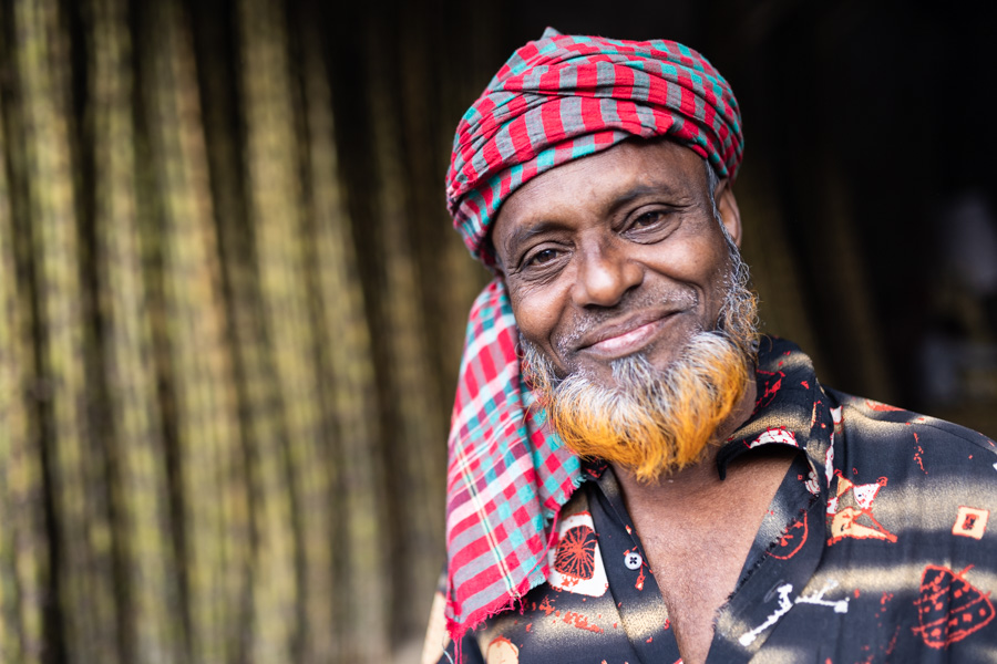 A man posing for a portrait in the streets of Dhaka