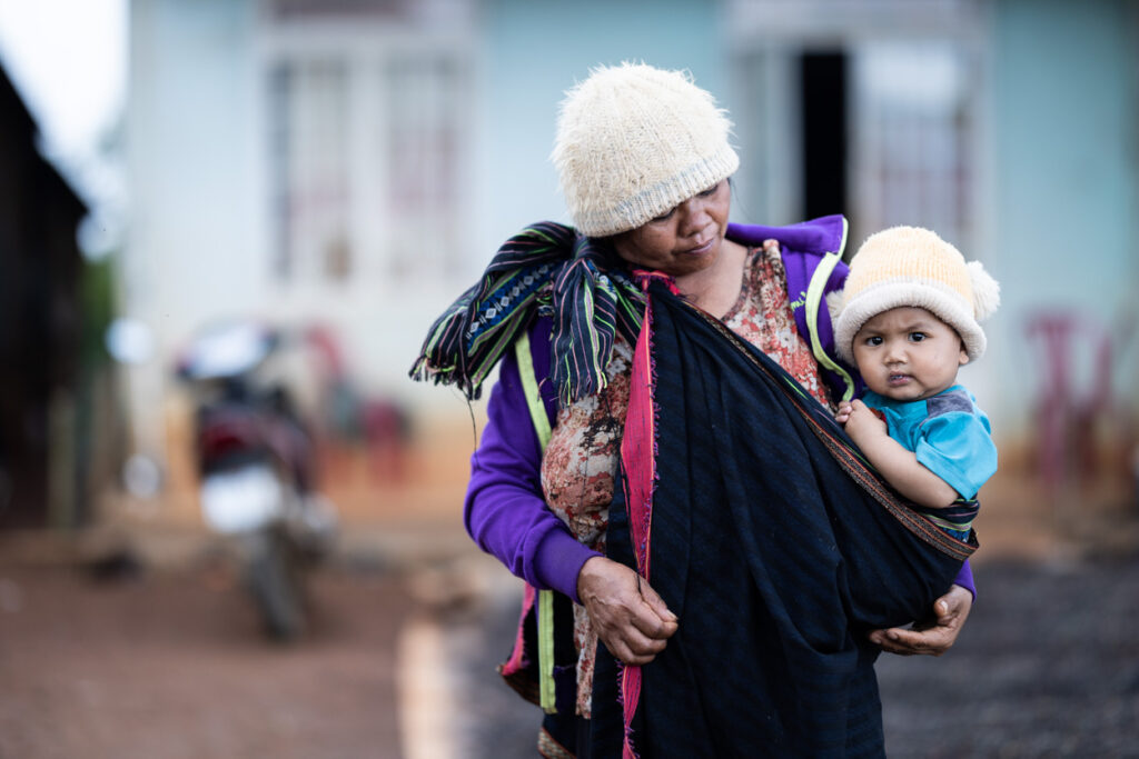 A woman and her baby being photographed near Dalat