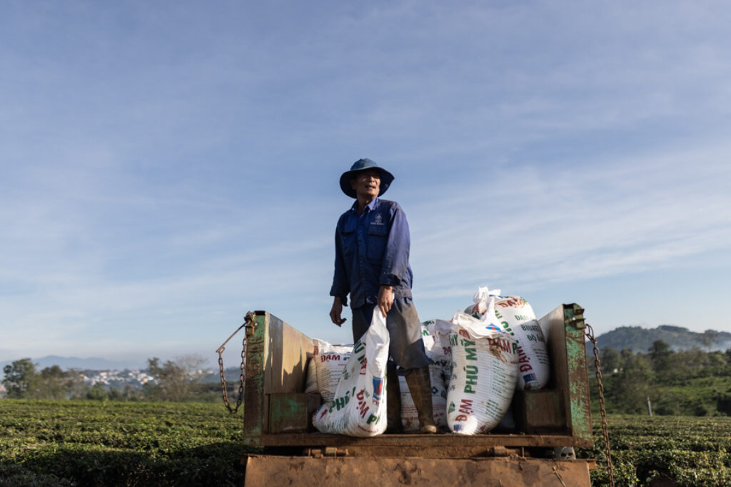 A man stands in a trucks filled with fertilizer in the central Vietnam Highlands